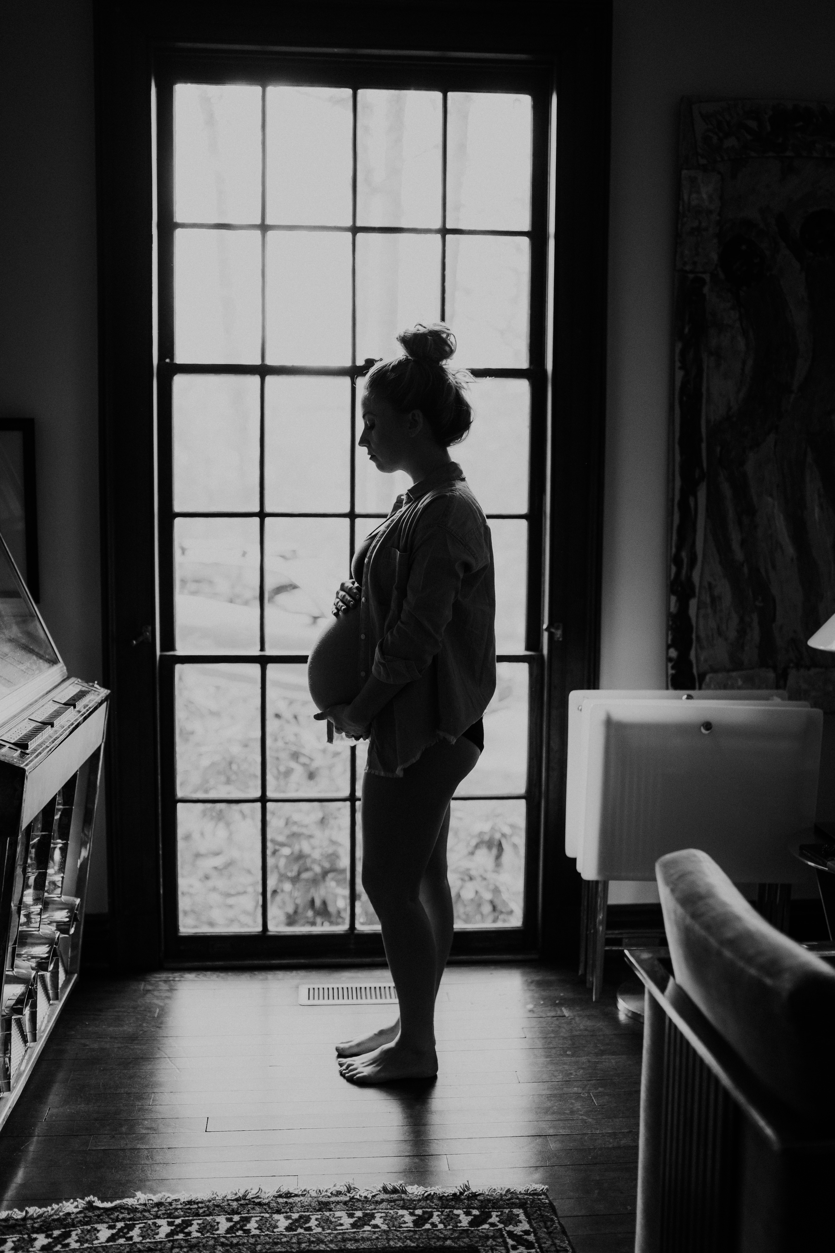 Intimate in-home maternity photography, pregnant mama near window