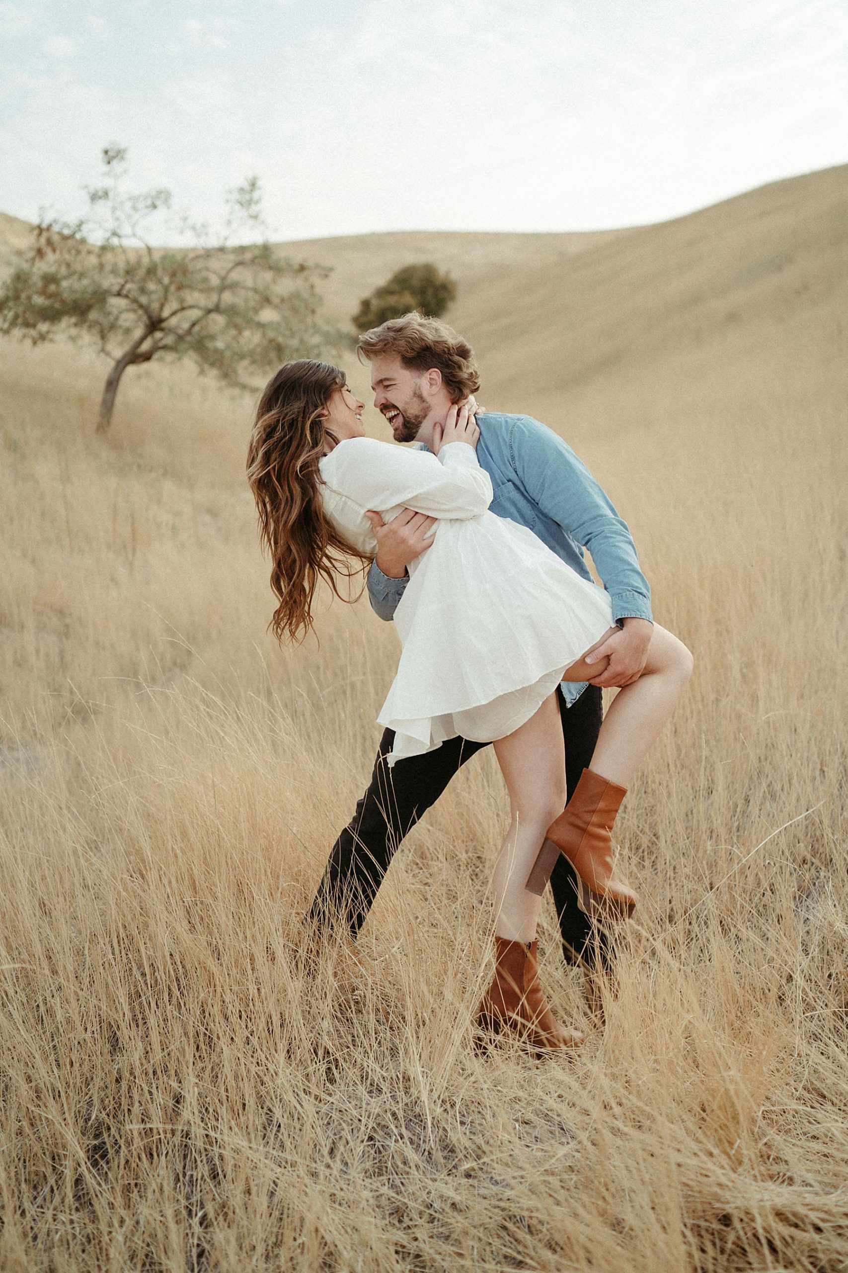 utah couple dancing in the grass at tunnel springs